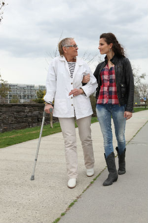 Elderly Lady Walking With A Young Woman